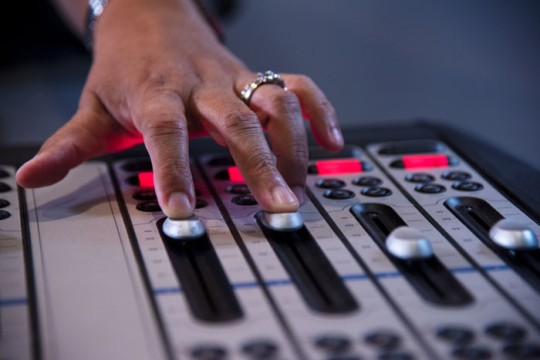 Hand on controls at the 98.9FM radio station
