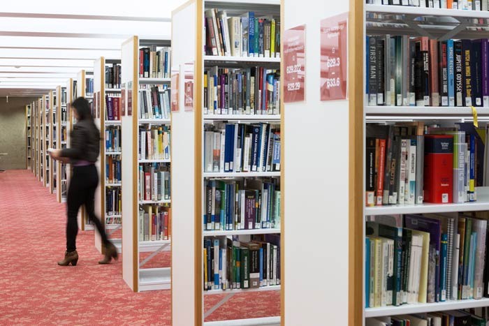 Woman in the shelves of the State Library. Photo by Jeff Camden.