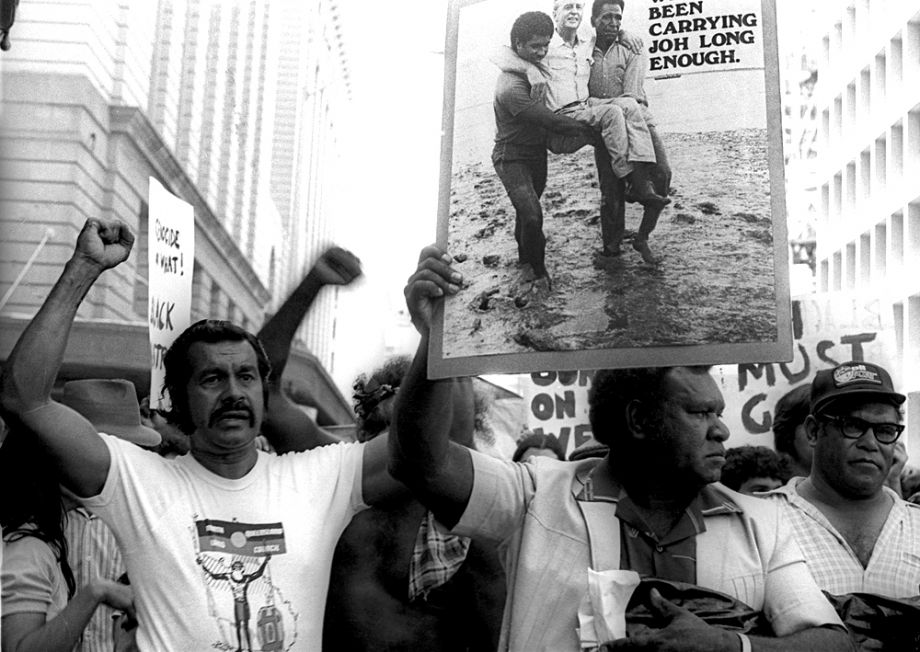 Uncle Steve protesting with We've been carrying Joh long enough placard