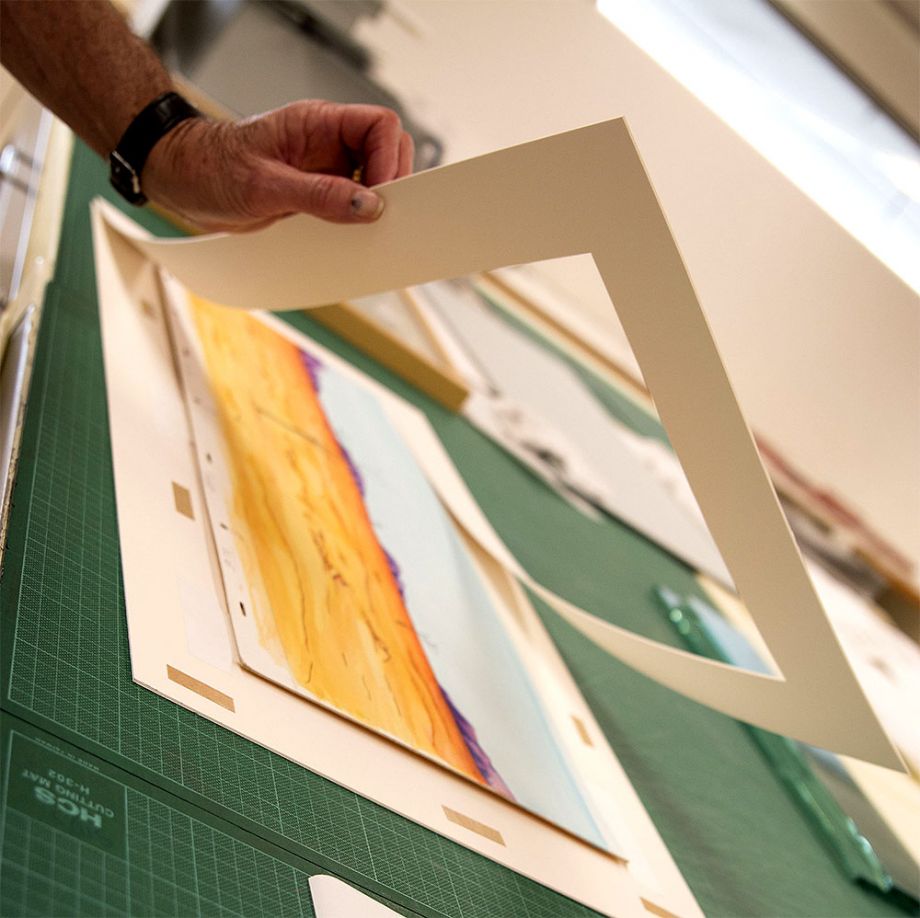 Photograph of watercolour artwork being framed from The Southern Cross