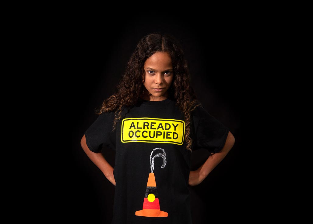 Shiloh Nakach wearing a Libby Harward designed "Already Occupied" shirt.