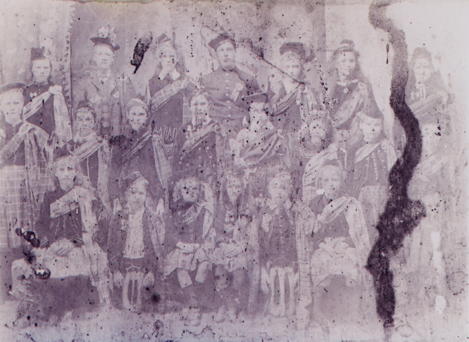 Group of men, women and children dressed in Scottish dress for Halloween, 1908