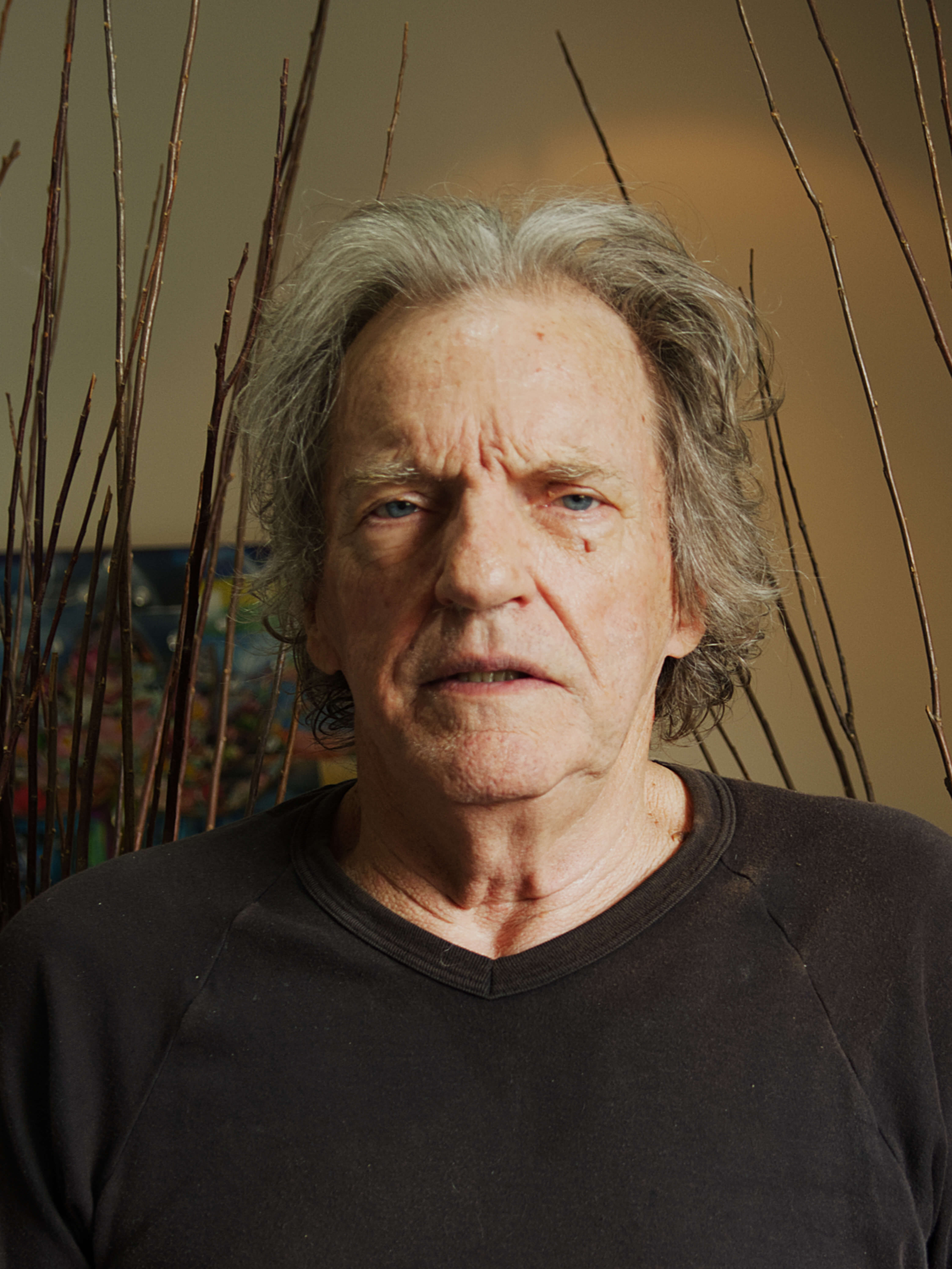 photographic portrait of Eddie Smitts, a middle ages man with grey hair looking directly at the camera wearing a black t-shirt