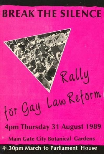 Break the silence: rally for Gay Law Reform. A pink poster with a black and white picture of protesters at a rally in the middle in the shape of a triangle.