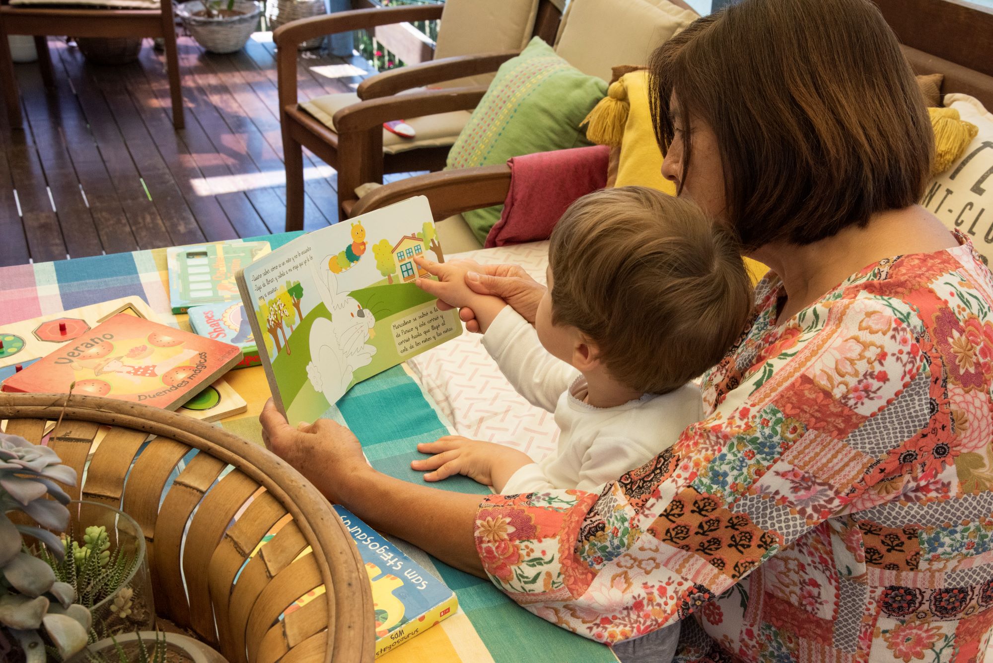 Woman reading book with child on her lap
