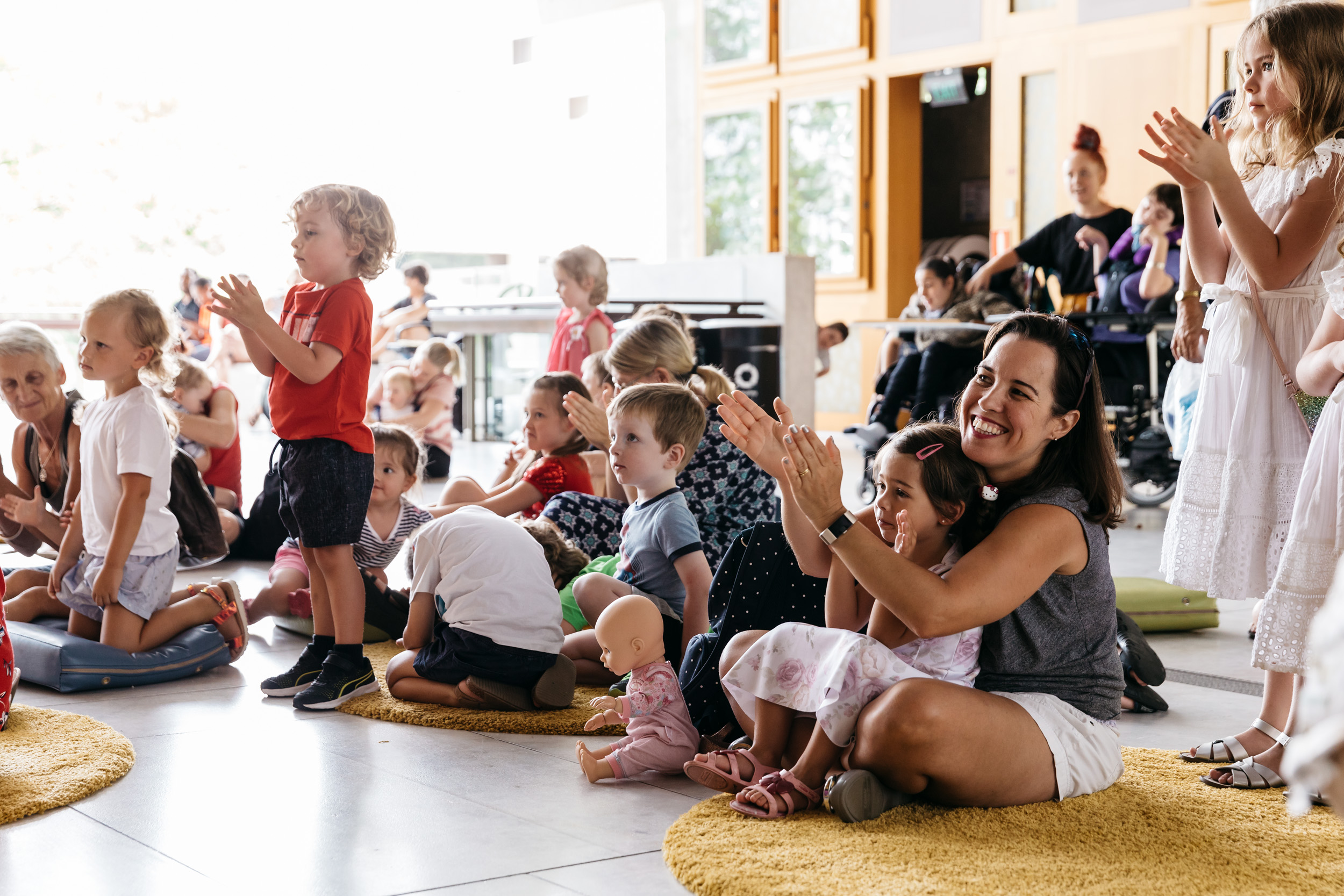 Children and families participating in story session on Queensland Terrace Children and families participating in story session on Queensland Terrace