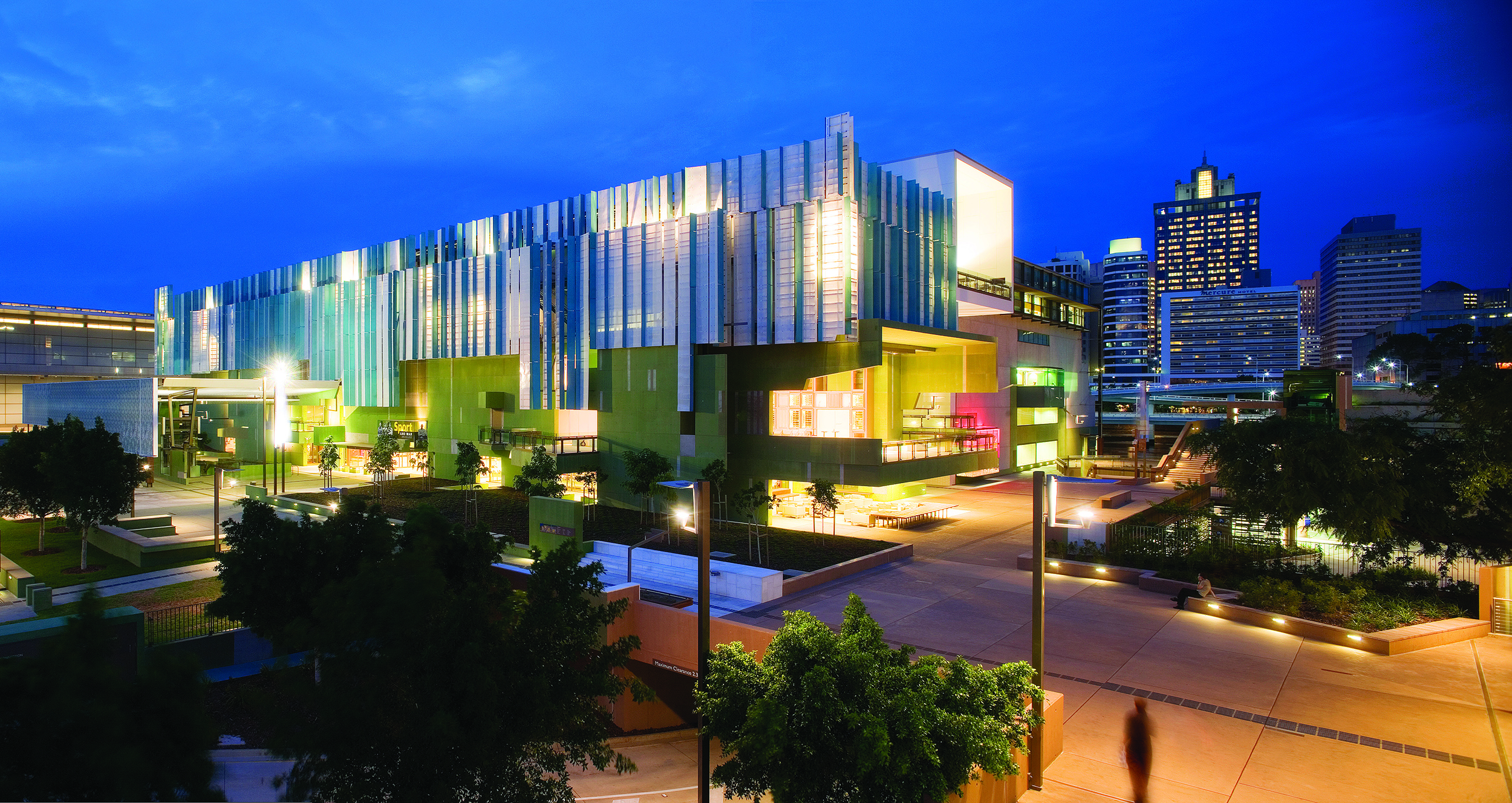 The award-winning State Library building at South Bank opened in 2006 State Library of Queensland building lit up at night