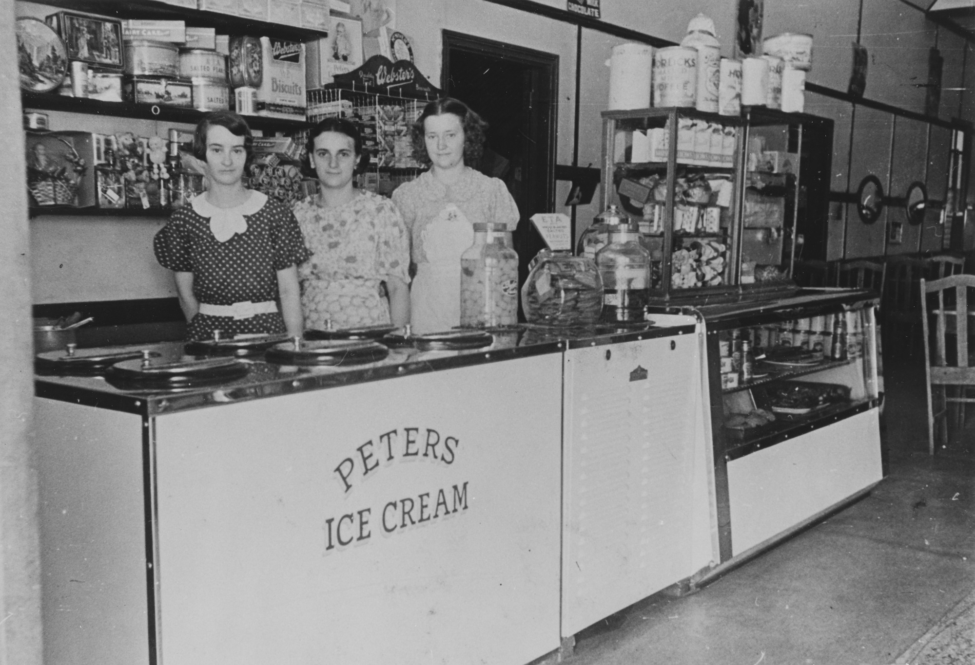 Three woman standing at Peters Ice Cream counter in cafe