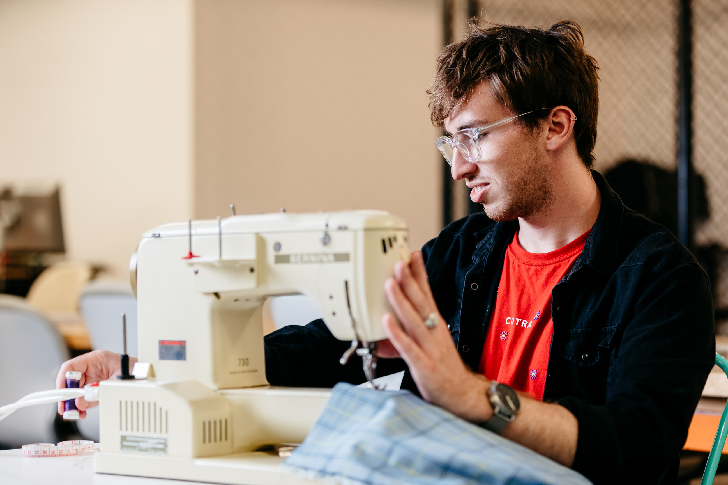 Teenager using a sewing machine