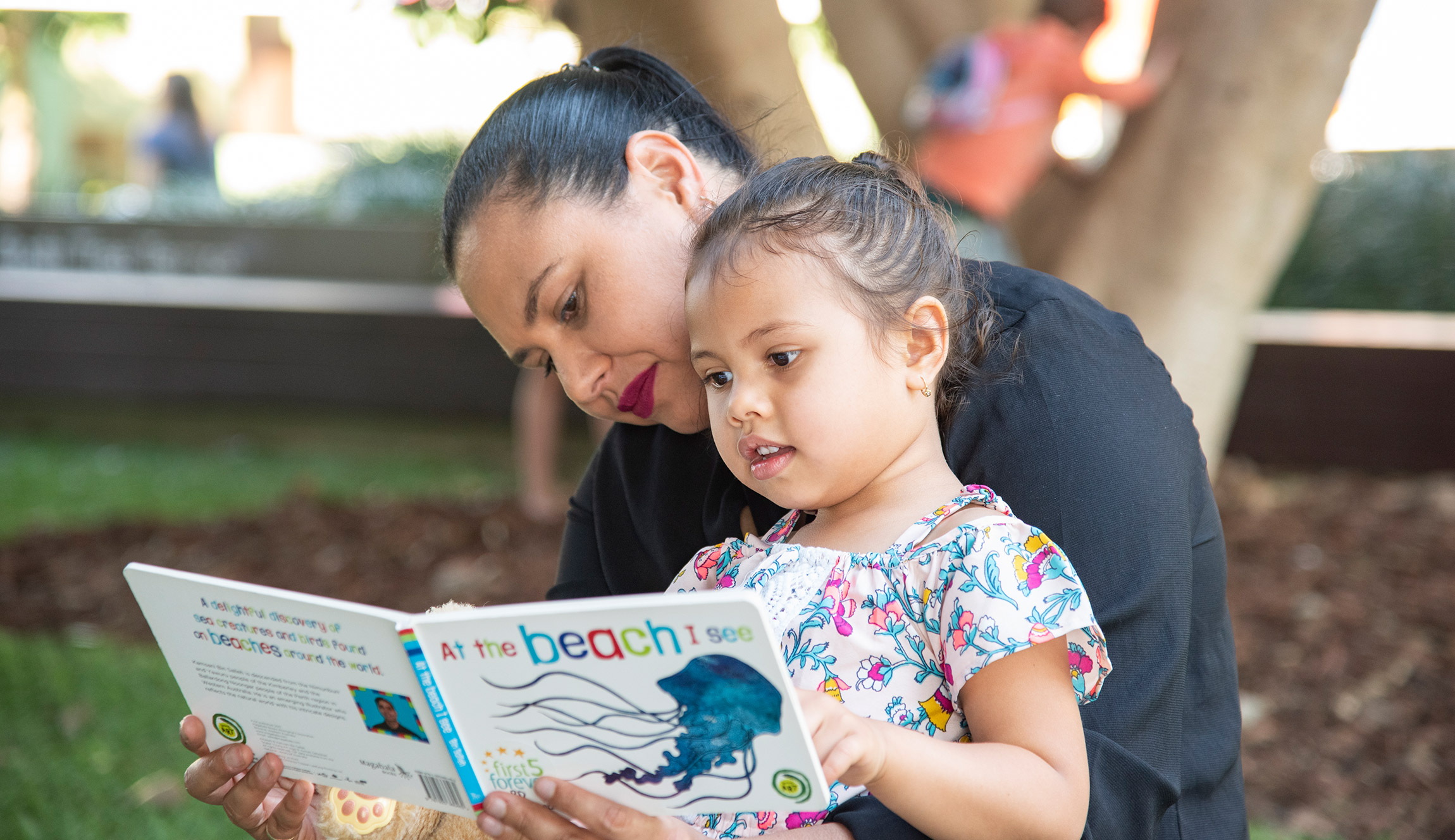 Family reading outside