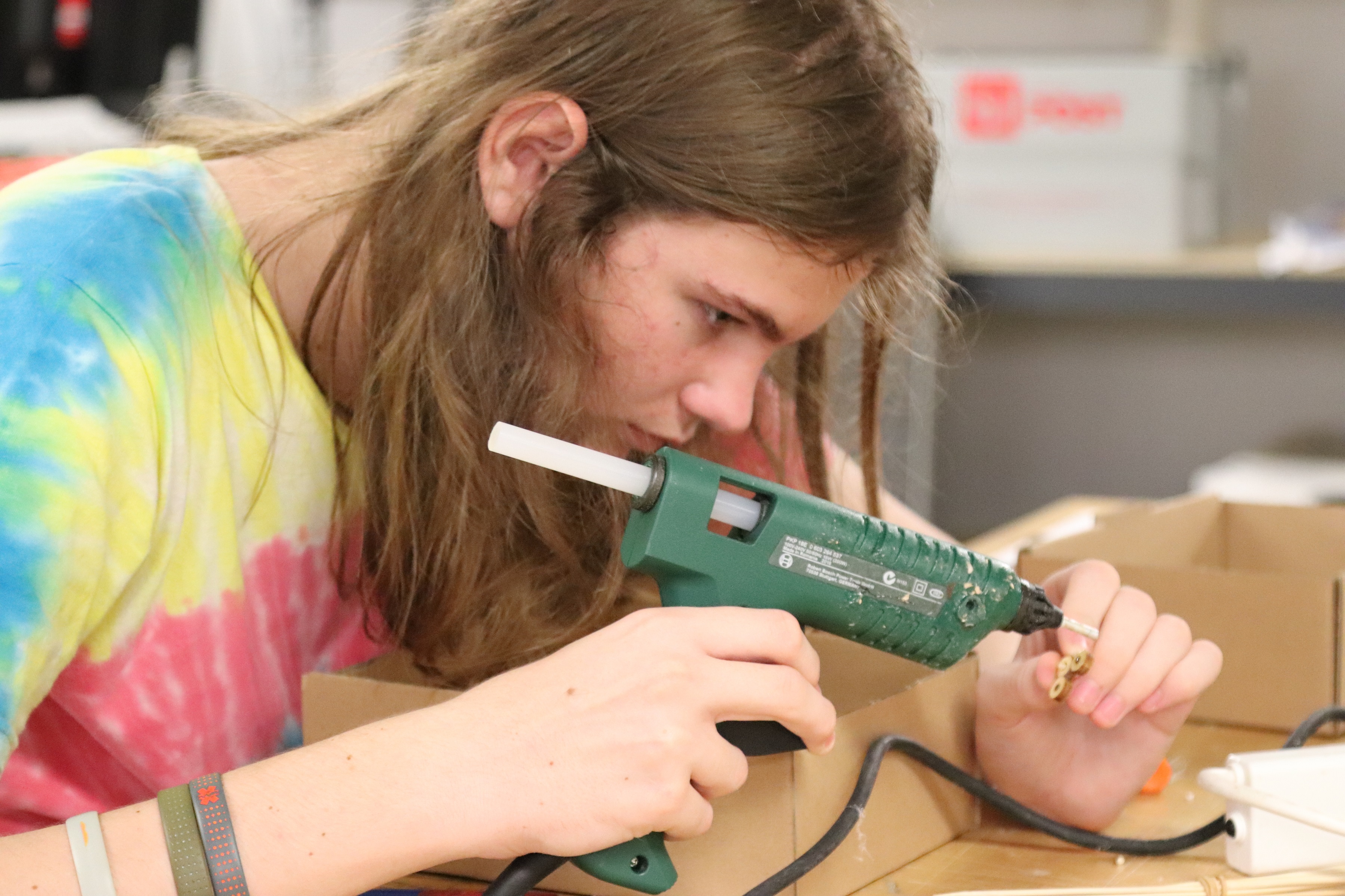 Hack the Evening participant hot gluing laser cut pieces