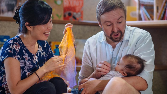 Parents singing to baby