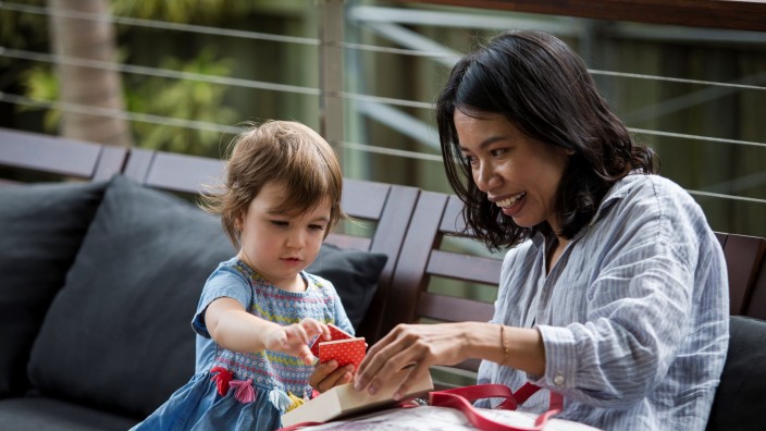 Mother and daughter looking at square tile