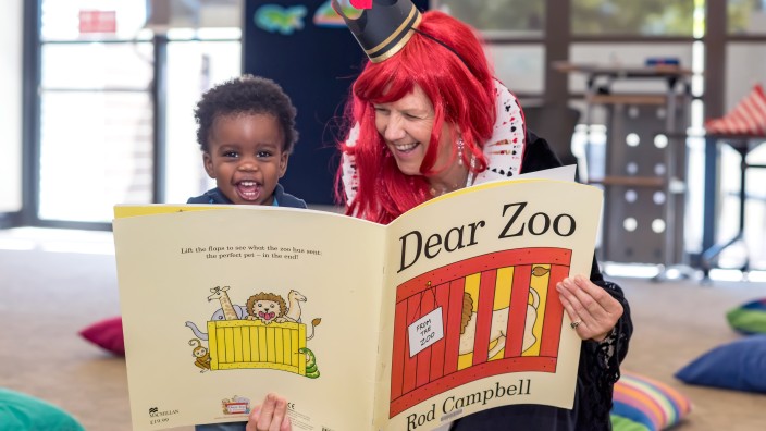 Library staff read giant book version of Dear Zoo at Toddler time 