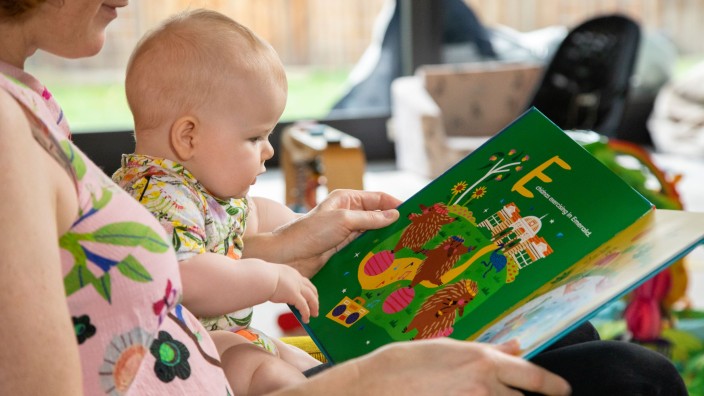 Mother and baby enjoying the book The Little Queenslanders Alphabet Book 