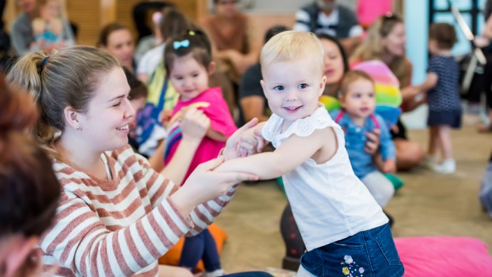 Woman and child dancing at Toddler time