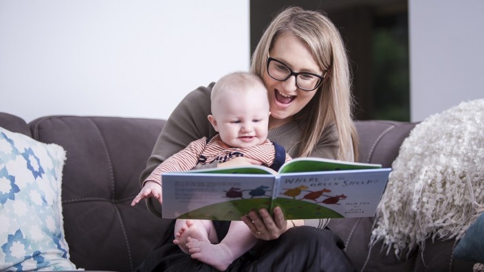 Adult shares a nominated book with baby