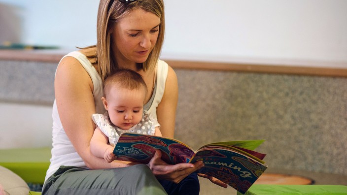 Mother reading book to child