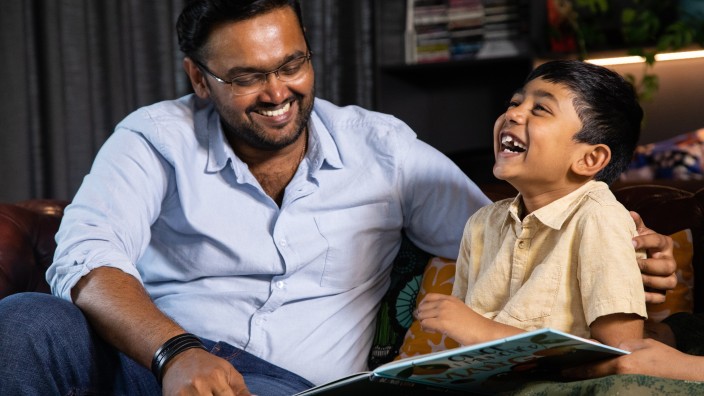 Father and child enjoy reading a book together