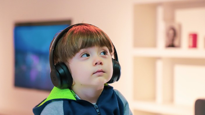 Young boy watching screen with headphones
