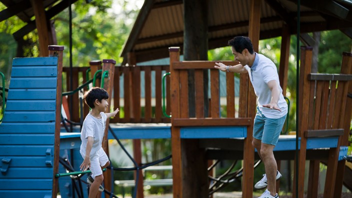 Photo by Jason Henry, 2020. Father and son on play equipment