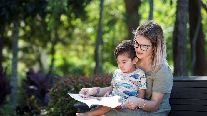 Mother and son reading at the park. Mother and son reading at the park