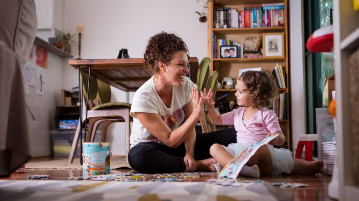 Mother and daughter sharing a high five