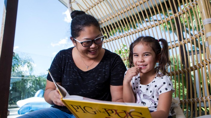Summer Reading Club Girl and mother reading outside