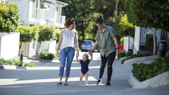 Parents walking outside with their baby Parents walking outside with their baby