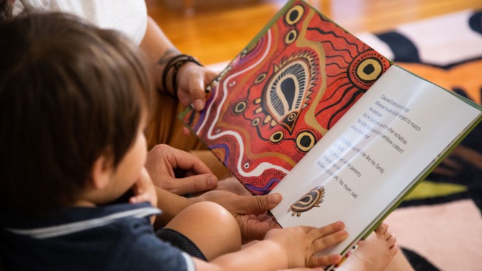 Family reading a book called The Coloured Echidna Family reading a book called The Coloured Echidna