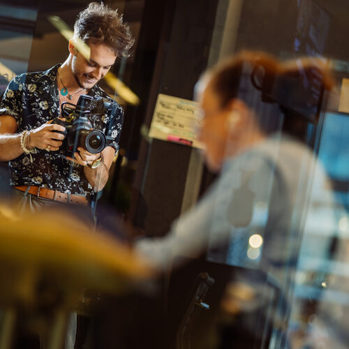 A photo of people through a glass window 