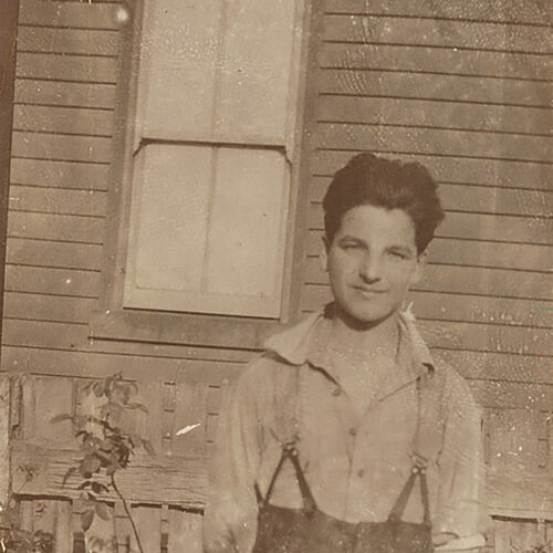 Informal portrait of Yvon Calmus, a young French war refugee 'souvenired' by members of the 2nd Field Artillery Brigade (2nd FAB) and brought back to Australia to live.