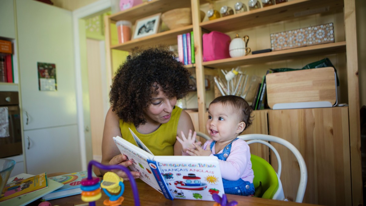 Mother and baby play reading