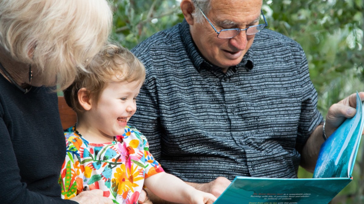Grandparents reading with child