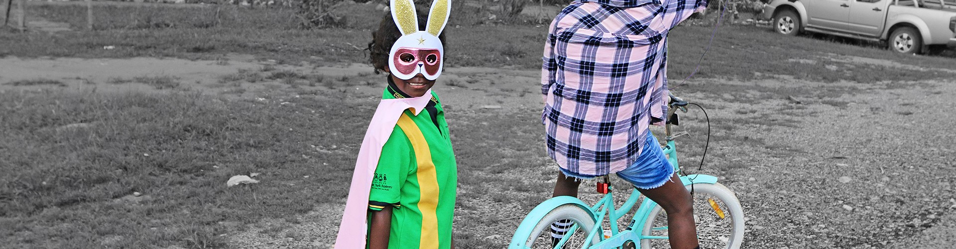 Young girl wearing a bunny mask and her mum taking a selfie outside