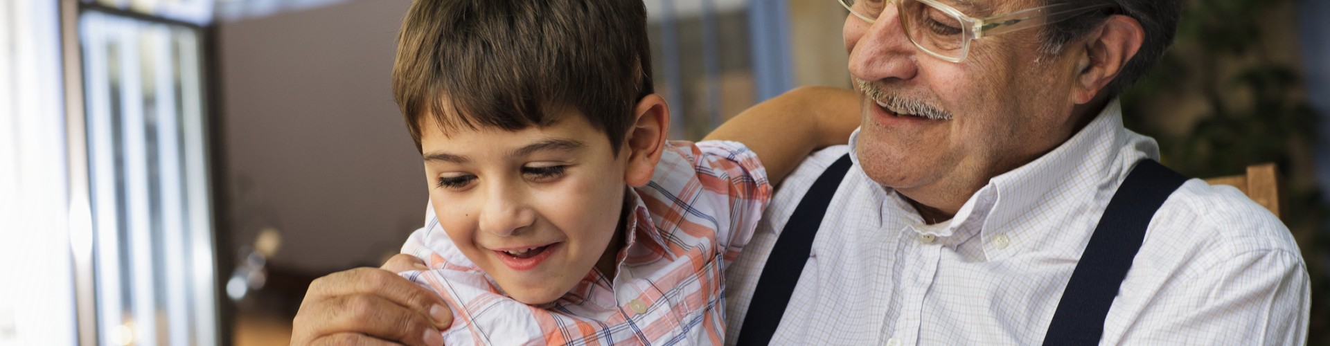 Man with child on his knee both smiling