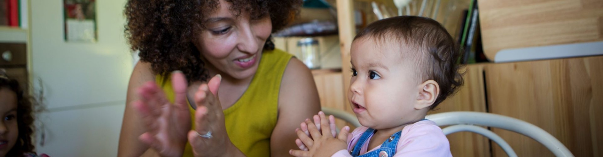 Woman and child using sign language to read a book