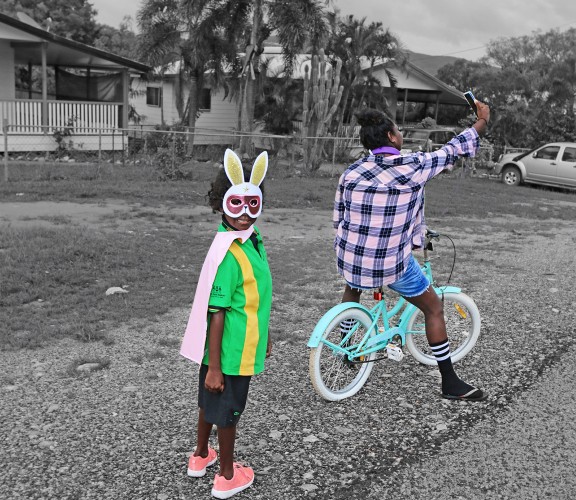 Young girl wearing a bunny mask and her mum taking a selfie outside