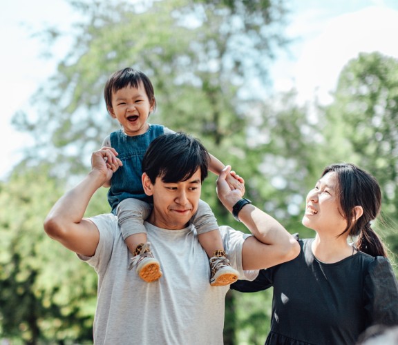 Mother and father with son on shouldres