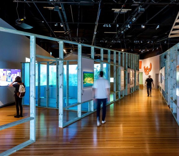 Three people exploring the Purpose Built exhibition.