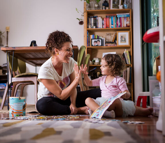 Mother and daughter sharing a high five