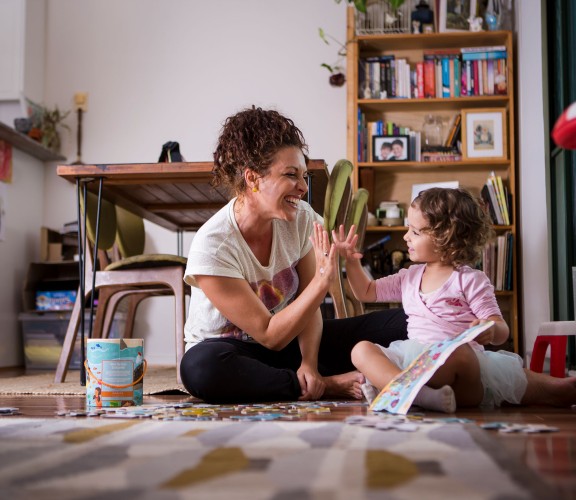 Mother and daughter sharing a high five