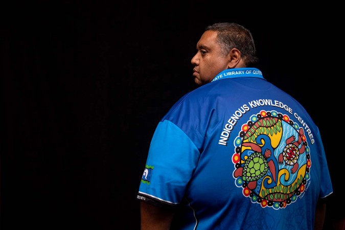 Indigenous man wearing Indigenous Knowledge Centre shirt