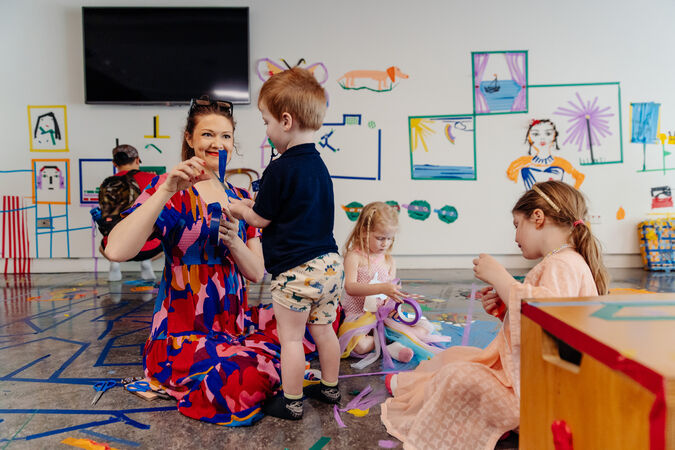 Children and adult crafting with tape