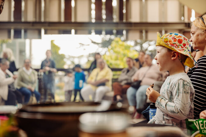 Children and adults watching performance