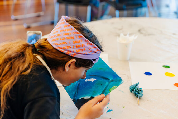Girl painting with nose