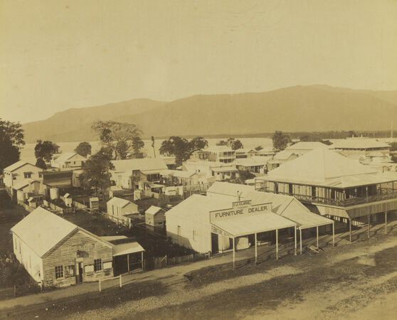 Shields Street in Cairns, Queensland, around 1890, featuring early colonial timber buildings and storefronts, on a dirt road.
