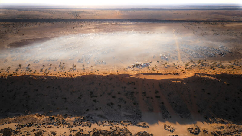 Big Red sand dune near Birdsville with Big Red Bash in background