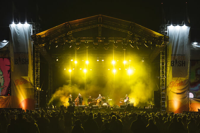 Concert stage lit up in yellow lights
