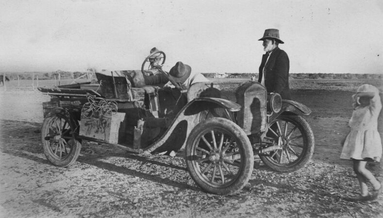 Two men and child with 1920s car